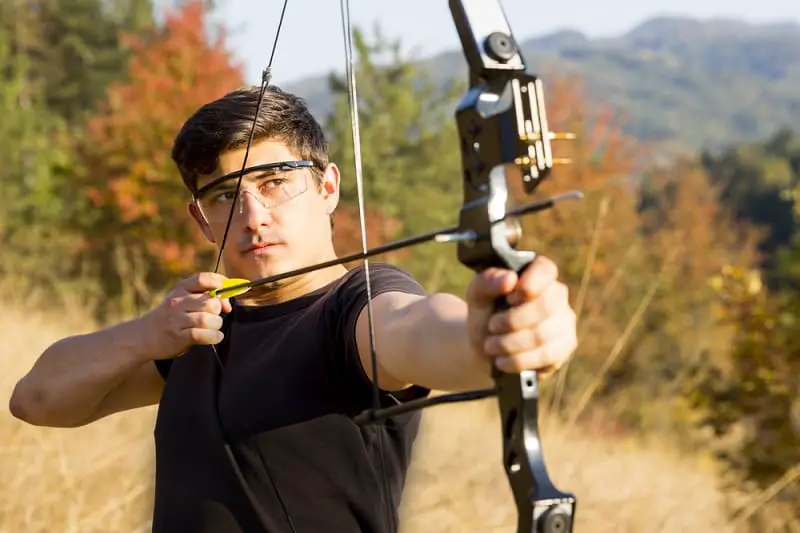 Man aiming compound bow
