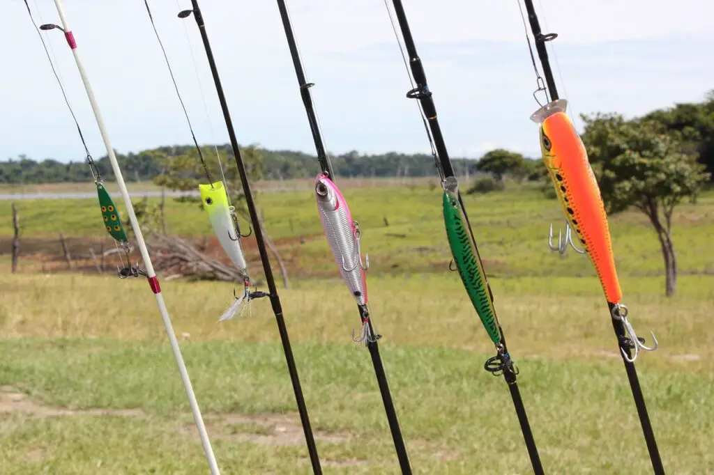 Colorful baits on a different types of fishing rod according to material