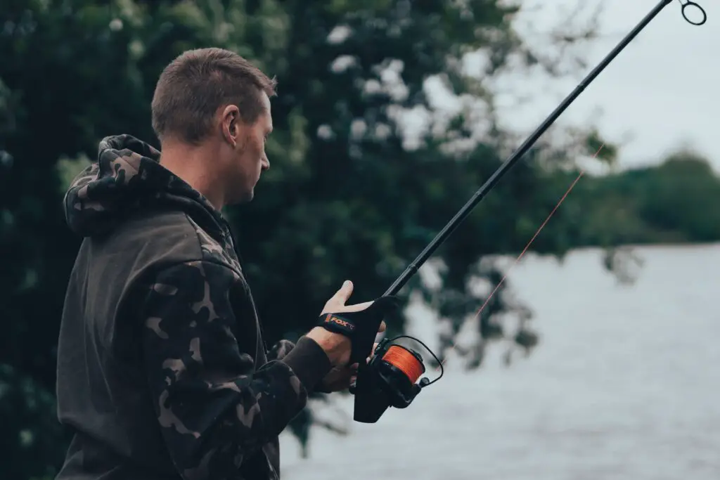 A man with his fishing rod with red braided fishing line