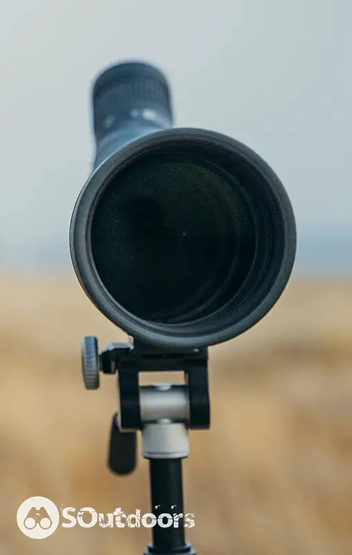 A close up camera shot on front lens of a spotting scope