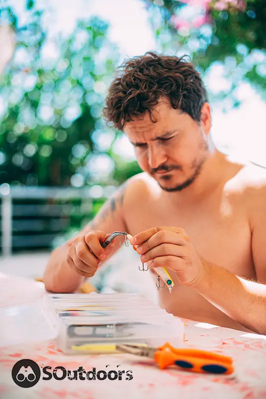 Fisherman fixing a fish hook