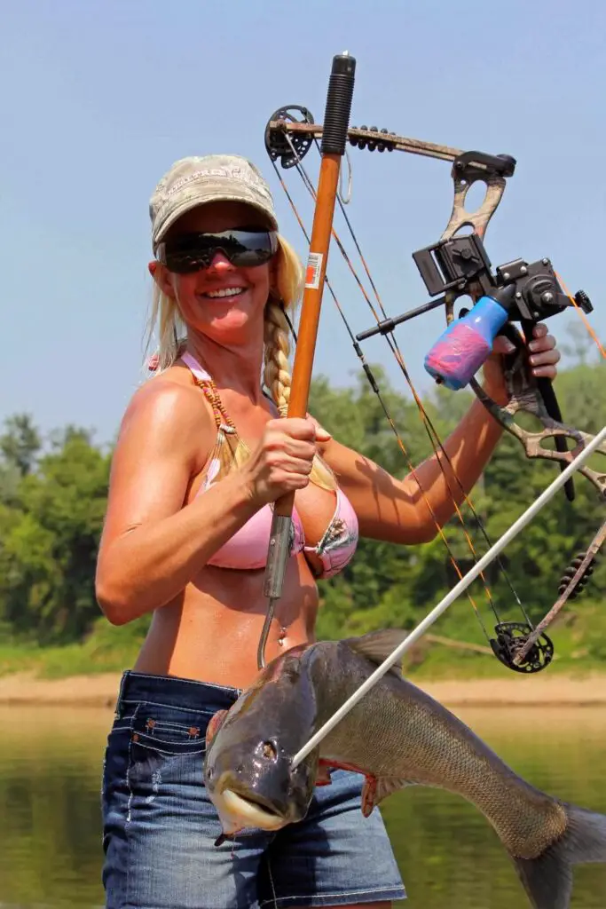 A woman bow fishing.